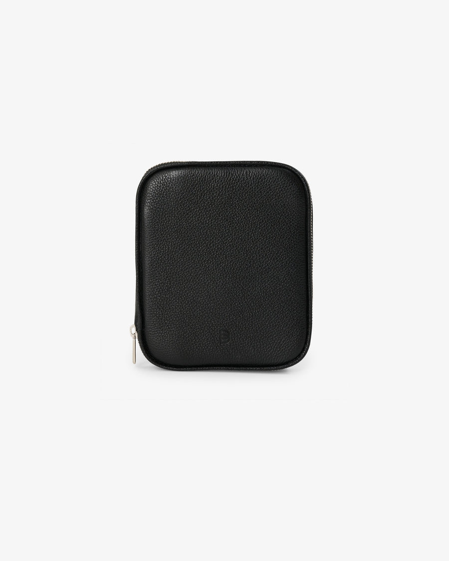 A black textured leather zippered pouch with rounded corners and a small silver zipper pull, shown on a plain light gray background.