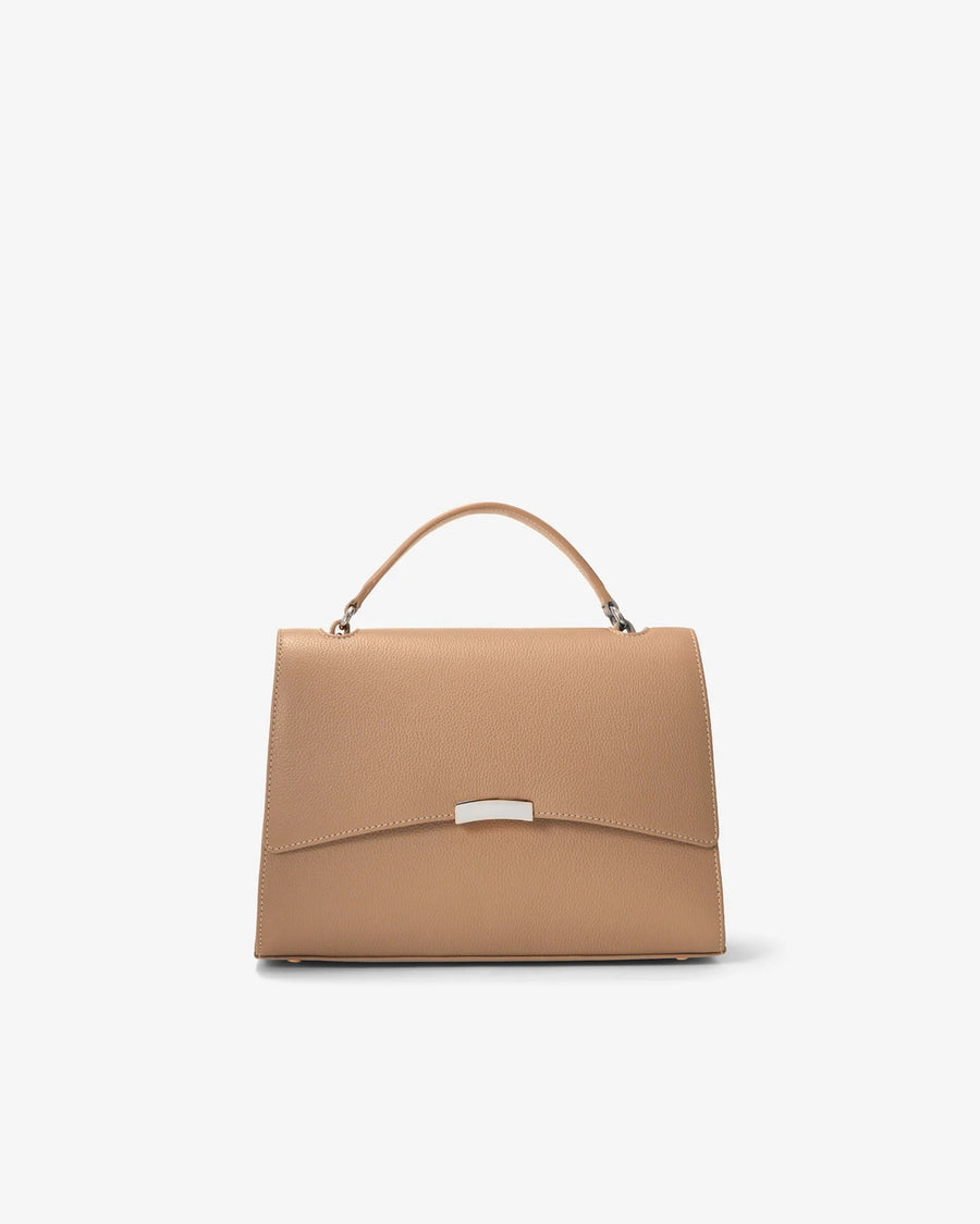 A structured top-handle handbag in tan leather with a silver-tone metal accent on the front flap, shown against a plain white background.