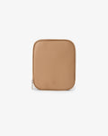 A tan pebbled leather travel pouch with rounded corners and a small embossed logo near the bottom center, shown on a clean white background.