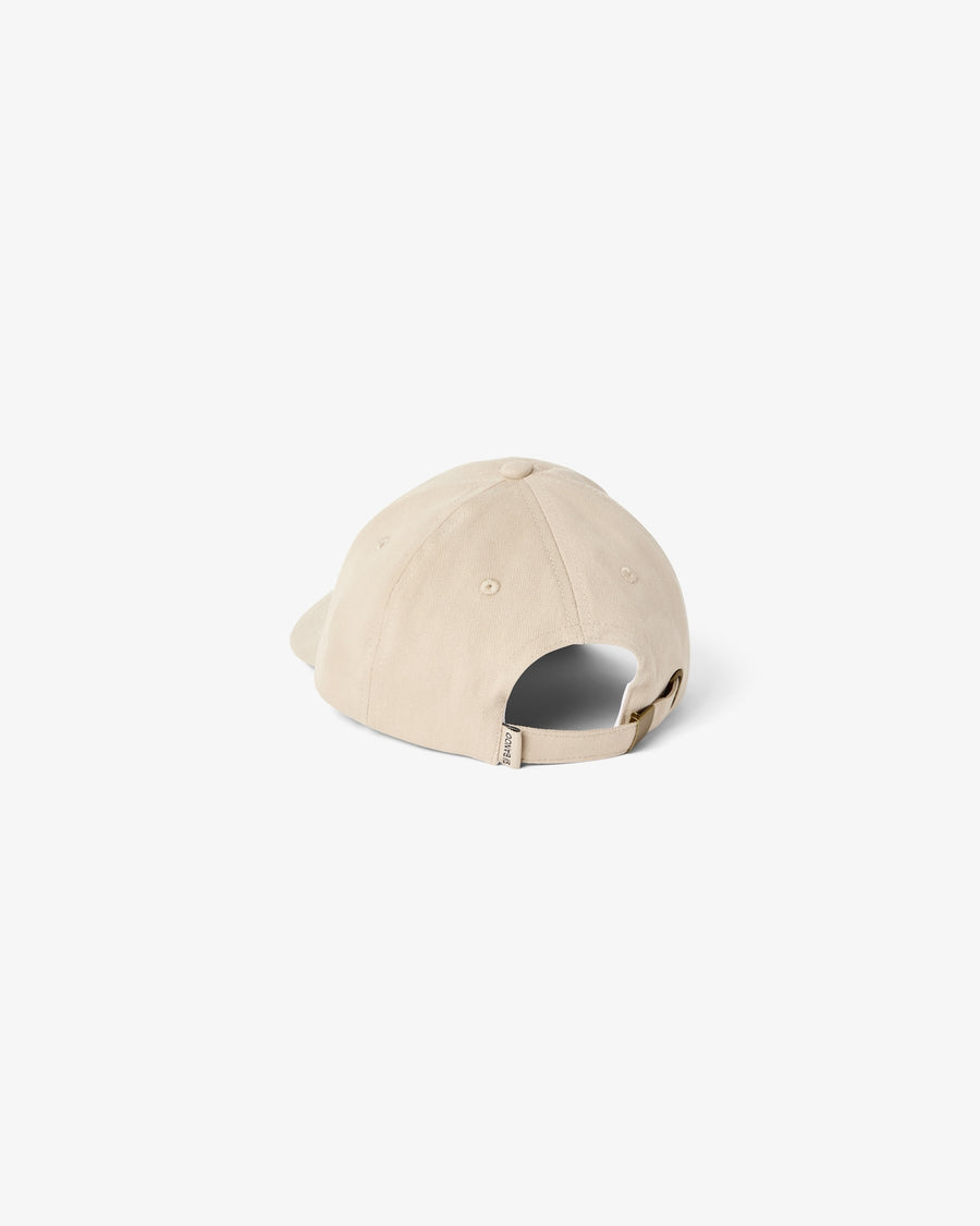 A light beige baseball cap shown from a rear three-quarter angle on a clean, solid off-white background.
