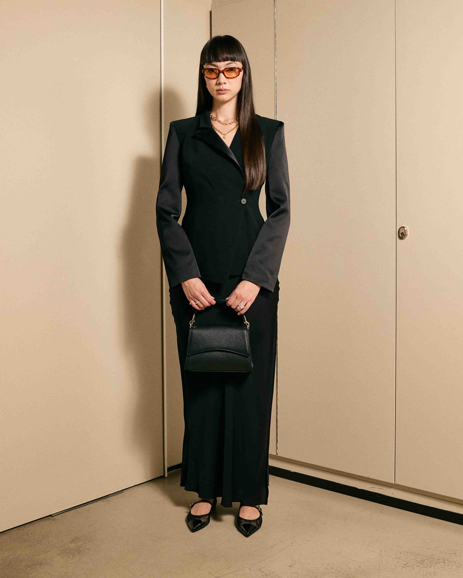 Elegant woman carrying the After Work Bag in black/silver – sophisticated for work and beyond.