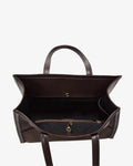 A dark brown leather tote bag shown from a top-down view, highlighting its spacious interior, dual top handles, and a zippered compartment with gold-tone hardware.