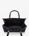 Top-down view of a structured tote bag with dark navy blue fabric body and black leather handles and trim, shown open against a plain white background.