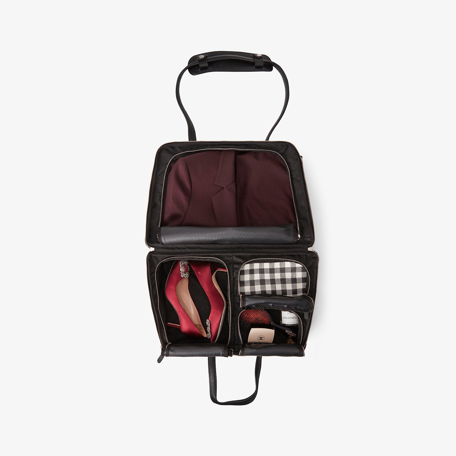 Inside the 24 Hour Suitcase in black/gold with organized compartments for garments and personal items – perfect for work trips or weekend getaways.