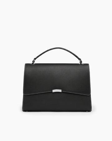 A black leather top-handle handbag with a flap closure, contrast stitching, and a small silver metal accent on the front, photographed against a plain white background.