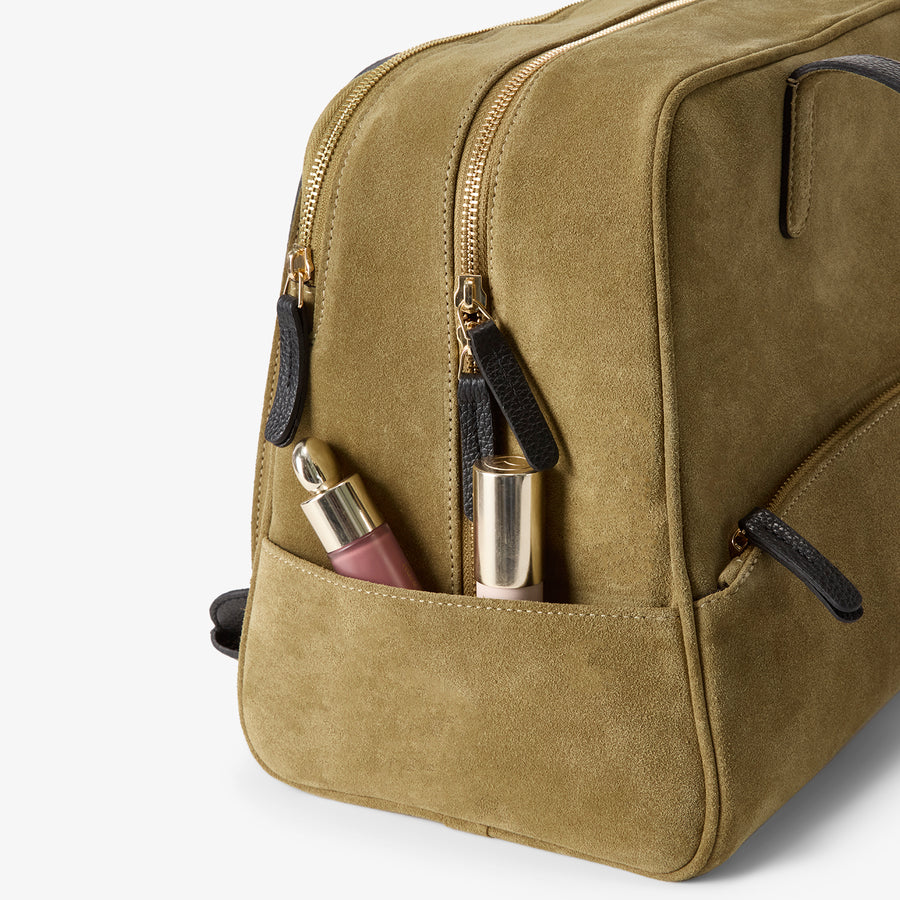 Close-up of the 12 Hour Duffel Bag in Olive/Gold, emphasizing its convenient side zippered pockets with black leather pulls, perfect for quick-access storage of small essentials.