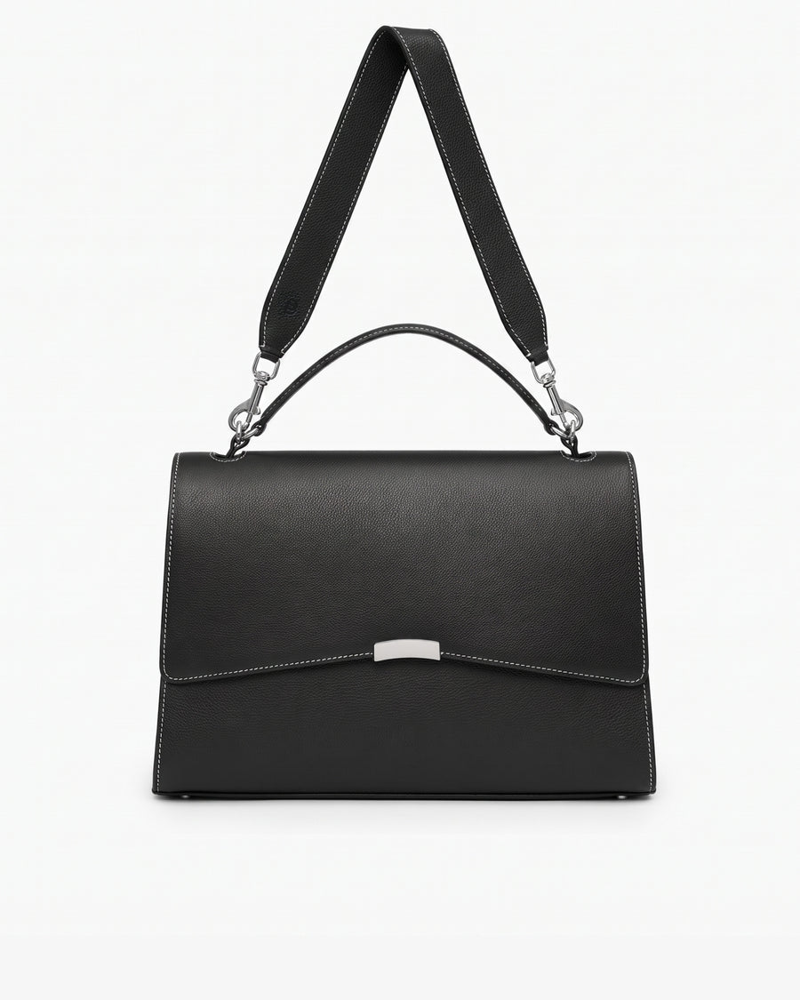 A structured black leather bag with a top handle, a detachable shoulder strap, contrast stitched seams, and a silver-tone metal accent on the front flap, shown against a plain white background.