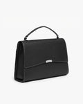 A black leather top-handle handbag with a silver-tone metal accent on the front flap and contrast stitched seams, shown from a three-quarters angle against a plain white background.