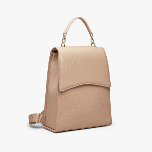 A beige grained leather backpack with light gold metalware. It has a detachable top handle and adjustable shoulder straps. It fits your laptop and other daily essentials.