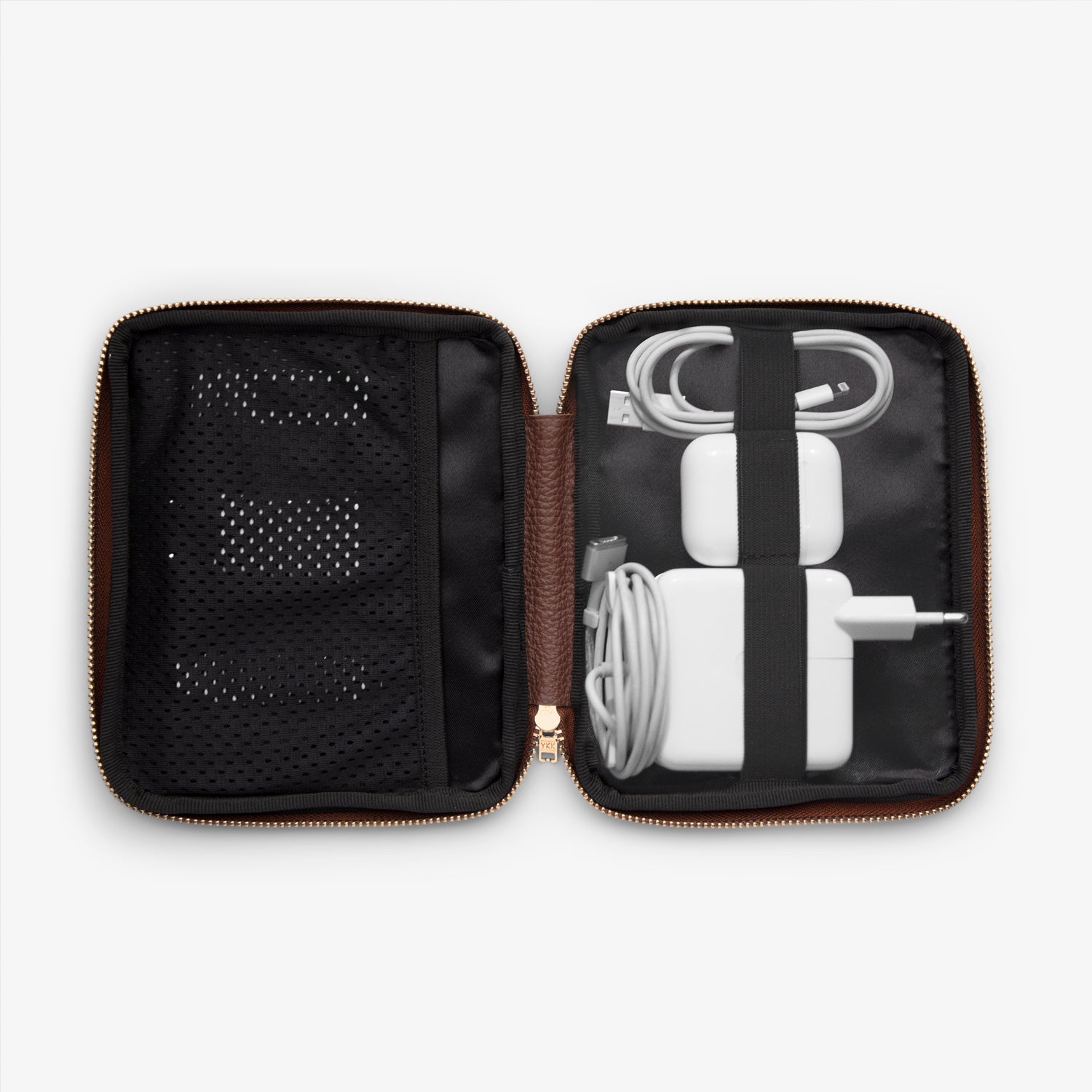 Shows the inside of a cable pocket displaying a computer charger, AirPods, phone charger, and USB stick, all neatly arranged and organized for easy access while on the go.