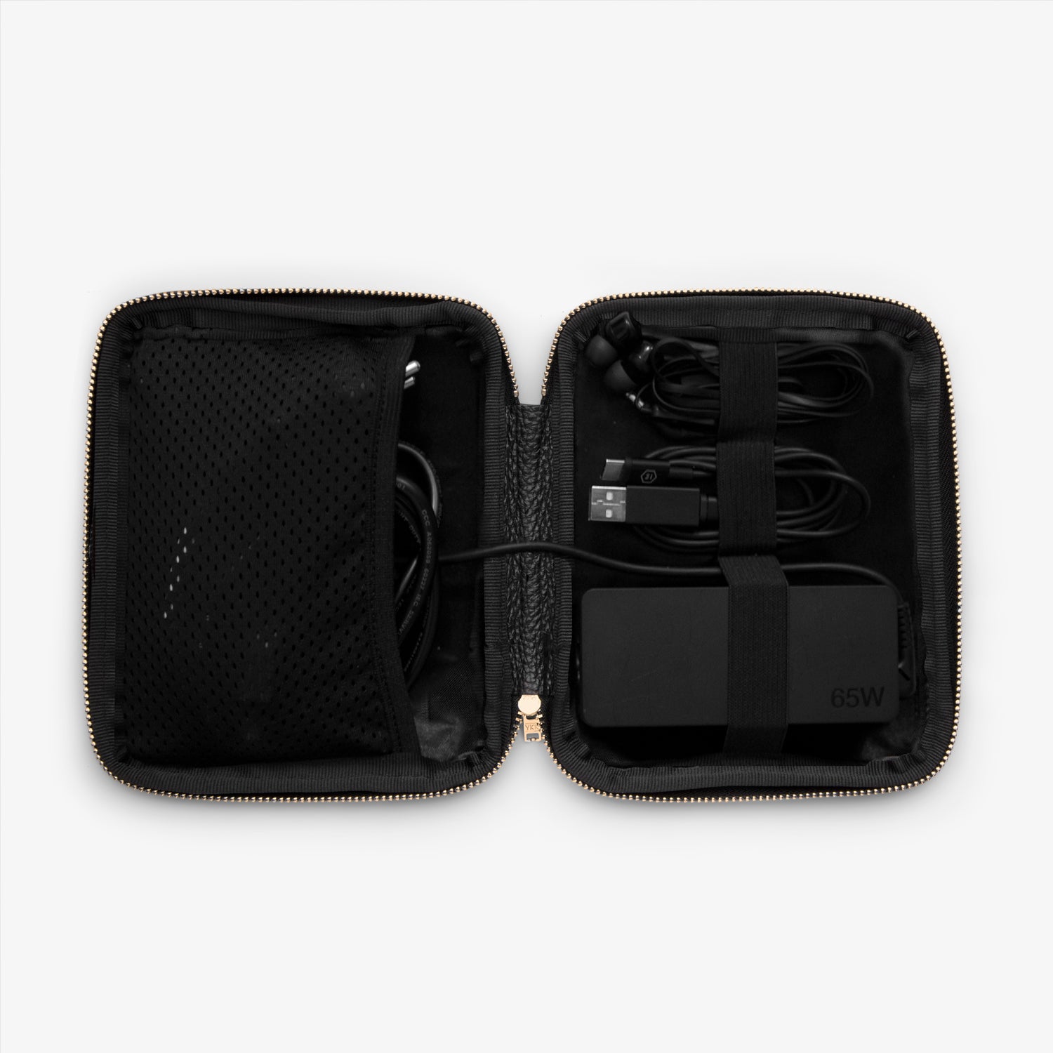 Shows the inside of a cable pocket displaying a computer charger, a phone charger, headphones and other cables, all neatly arranged and organized for easy access while on the go.