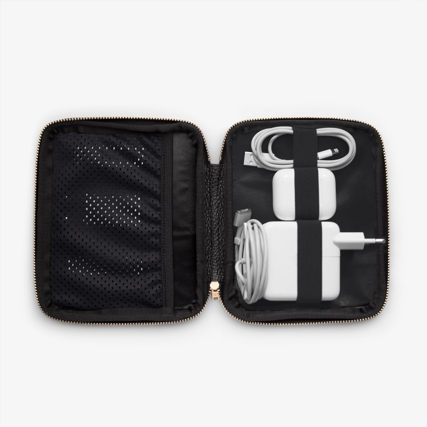 Shows the inside of a cable pocket displaying a computer charger, AirPods, phone charger, and USB stick, all neatly arranged and organized for easy access while on the go.