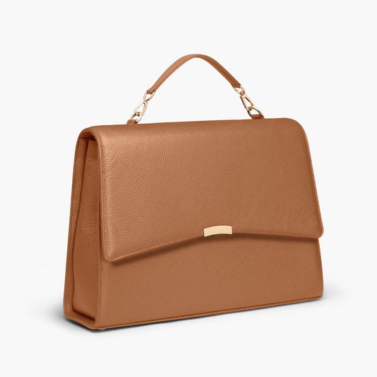 A caramel colored laptop bag in grained leather with light gold metalware. It has a detachable top handle and a detachable shoulder strap. The bag fits your laptop and other daily essentials. 